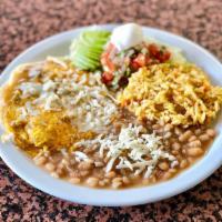 HUEVOS RANCHEROS · Corn tortillas topped with two cage free eggs any style, salsa ranchera served with Rice and...
