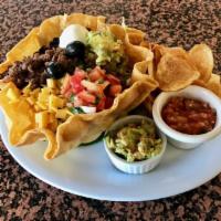 Spanish Tostada Salad · Chicken breast, Angus ground beef with tomato, black olives, black beans, cheddar cheese, gu...