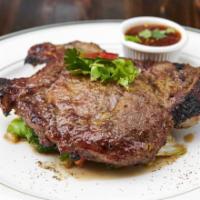 Pork Chop · Marinated with cilantro seed and Thai herb with spicy tamarind dip and sauteed mix vegetable.