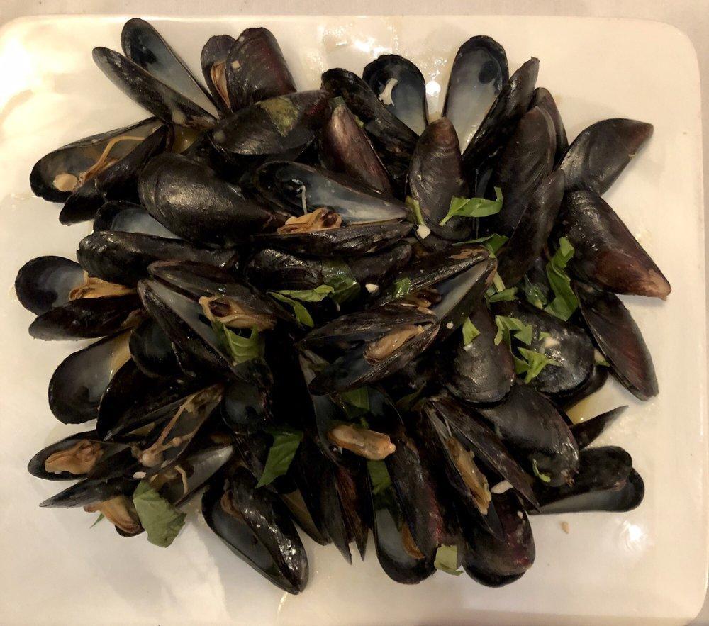 Mussels · Fresh cultivated mussels, steamed and seasoned in a white wine garlic and herb broth or in a marinara tomato sauce.