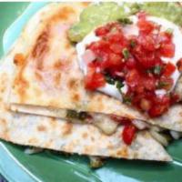 Quesadilla De Queso · Chihuahua cheese, queso fresco and Monterrey jack cheese melted between a grilled flour tort...