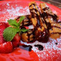 Churros · Mexican fried pastry tossed in cinnamon-sugar and served with chocolate sauce.
