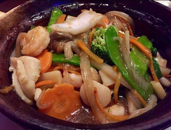 House Special Seafood · Shrimps, scallops, squid, black mushrooms, snow peas, carrots and broccoli sauteed in a spicy brown sauce, served on a clay pot.