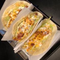 Korean Tacos · Chicken or marinated ribeye over 3 warm flour tortillas filled with crisp lettuce and colesl...