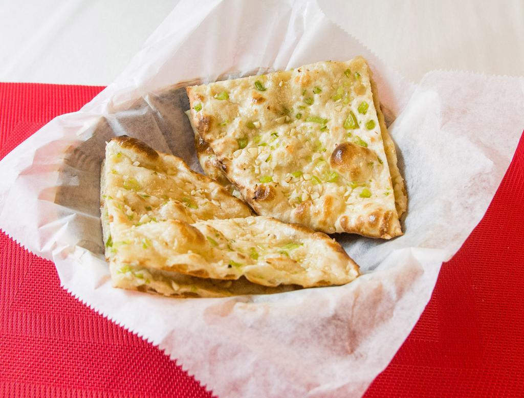 Garlic Naan · Oven-baked flatbread topped with garlic. 