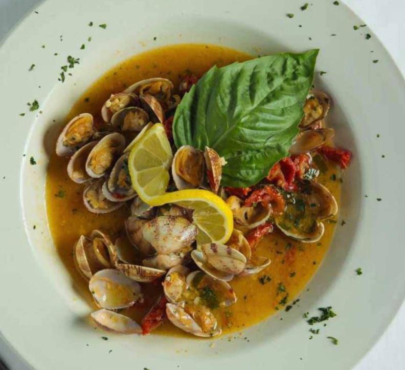 Clams Casino · Baby clams sauteed with sun-dried tomatoes in a roasted garlic and white wine lemon butter sauce.