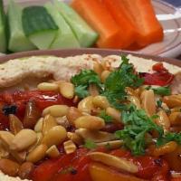 Hummus Delight · Sauteed almonds and pine nuts over hummus. our spicy dressing optional.
