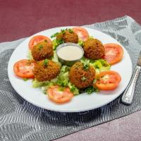 Falafel · Ground chickpeas mixed with fresh parsley, fresh garlic, onions, and spices, deep-fried, Ser...