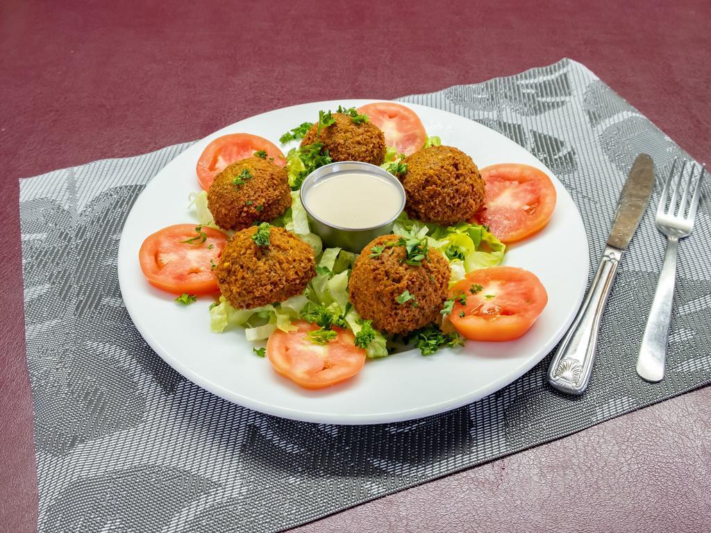 Falafel · Ground chickpeas mixed with fresh parsley, fresh garlic, onions, and spices, deep-fried, Served on a bed of lettuce, tomatoes, and tahini sauce.

