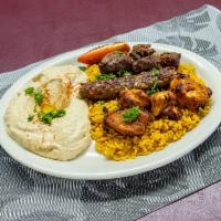 Traditional Combination Platter · Combination dish of lamb kafta, chicken kebob and shish kebob, topped with tahini sauce.