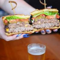 CJ's Burger · Lean beef patty cooked perfection, loaded on a brioche bun, add lettuce, tomato, onions and ...