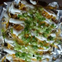 Bud's Spud · Huge baked potato, loaded with your choice of three meats and add sour cream, cheese or chiv...