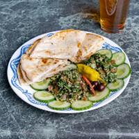 Tabouleh Salad · An Arabic salad of Bulghur wheat, chopped tomatoes, onion, mint and parsley, tossed with oli...