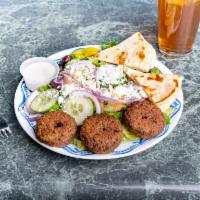 Falafel Salad · Warm falafel nuggets on top of a bed of fresh crisp Roman lettuce, tomatoes, pita bread and ...