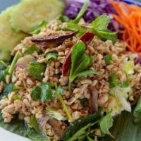 Larb Gai Salad · Ground chicken breast, roasted rice, Iceberg lettuce, green beans, cucumbers, onions, cilant...