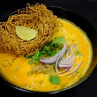 Khao Soi Noodle Soup · Thin rice noodles, bean sprouts, yellow curry, crispy noodles, crispy shallots and cilantro.