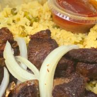 Fried Goat · Marinated Goat with your choice of rice and 2 sides