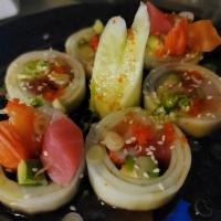 Naruto Maki · Avocado, kani, sashimi, no rice, wrapped in cucumber, snow crab, masago and ponzu sauce.