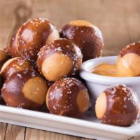 Pretzel Bites · Baked to perfection and served with queso
