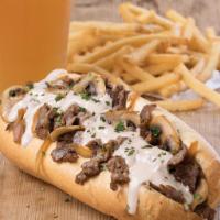 The Chipotle Philly · Grilled sirloin, caramelized onions and mushrooms, chipotle aioli and queso in a traditional...