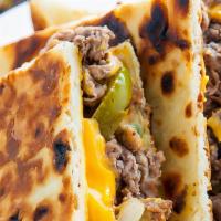 Quesadilla Philly Deluxe Style* · Juicy Tender Beef or Chicken in our Signature Sauce, Peppers, Onions, Mushrooms,  Provolone ...