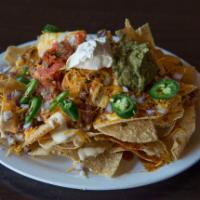 Ultimate Nachos · Tri-colored tortilla chips smothered in chili, queso blanco, cheddar cheese, sour cream, fre...