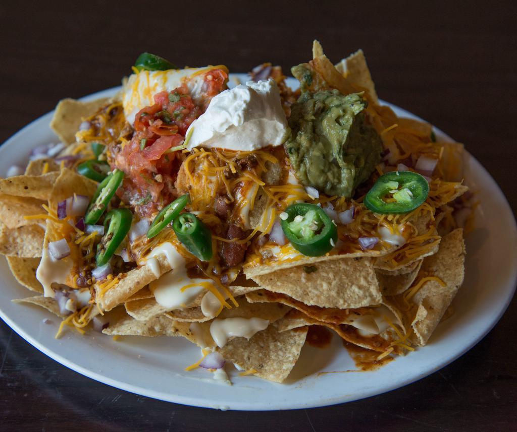 Ultimate Nachos · Tri-colored tortilla chips smothered in chili, queso blanco, cheddar cheese, sour cream, fresh guacamole, red onions, jalapenos and salsa.