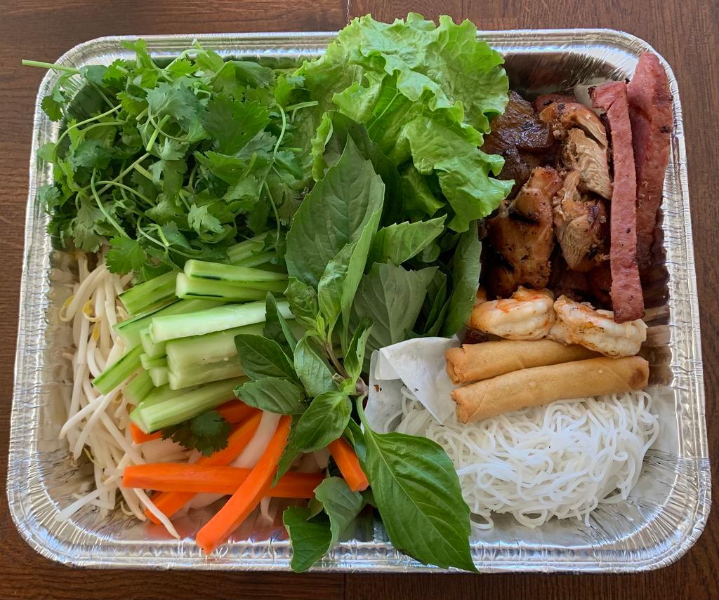 Viet Platter · Our Viet Platter is a family style, build-your-own fresh roll kit, fit for 4-5 people. Includes grilled pork, grilled lemongrass chicken, grilled prawns, Vietnamese spam, veggie egg rolls, rice noodles, lettuce, pickled carrots & daikon, cucumber, jalapeños, beansprouts, cilantro, and basil, topped with fried shallots, scallions, and crushed cashews. Served with rice papers to wrap and fish sauce on the side. (Not gluten free.)