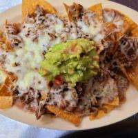 Nachos Supreme · Beans, cheese, sour cream , guacamole and your choice of meat.