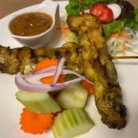 Chicken Satay · Tender pieces of herb-marinated chicken breast skewered and served with our homemade peanut ...