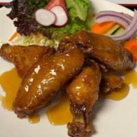 Caramel Chicken Wings · Golden-fried chicken wings warmly tossed in a pan of our special sweet and savory caramel sa...