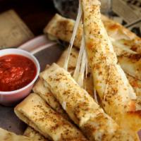 Italian Fries with Cheese · Our flaky thin pizza crust folded in half and filled with mozzarella cheese, topped with gar...