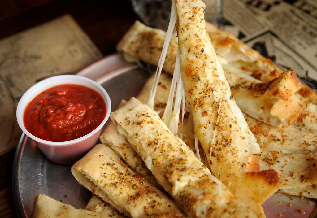 Italian Fries with Cheese · Our flaky thin pizza crust folded in half and filled with mozzarella cheese, topped with garlic butter and our special spices. Served with dipping sauce.