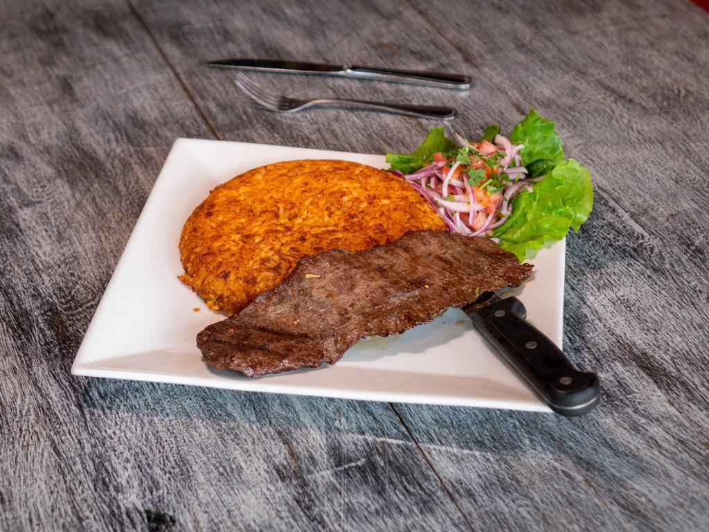 Churrasco con Tacu Tacu · Skirt steak with mixed white beans and rice.