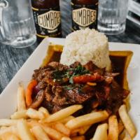Lomo Saltado con Arroz Blanco · Sauteed beef with tomatoes, onions, and cilantro. Served over french fries and white rice.