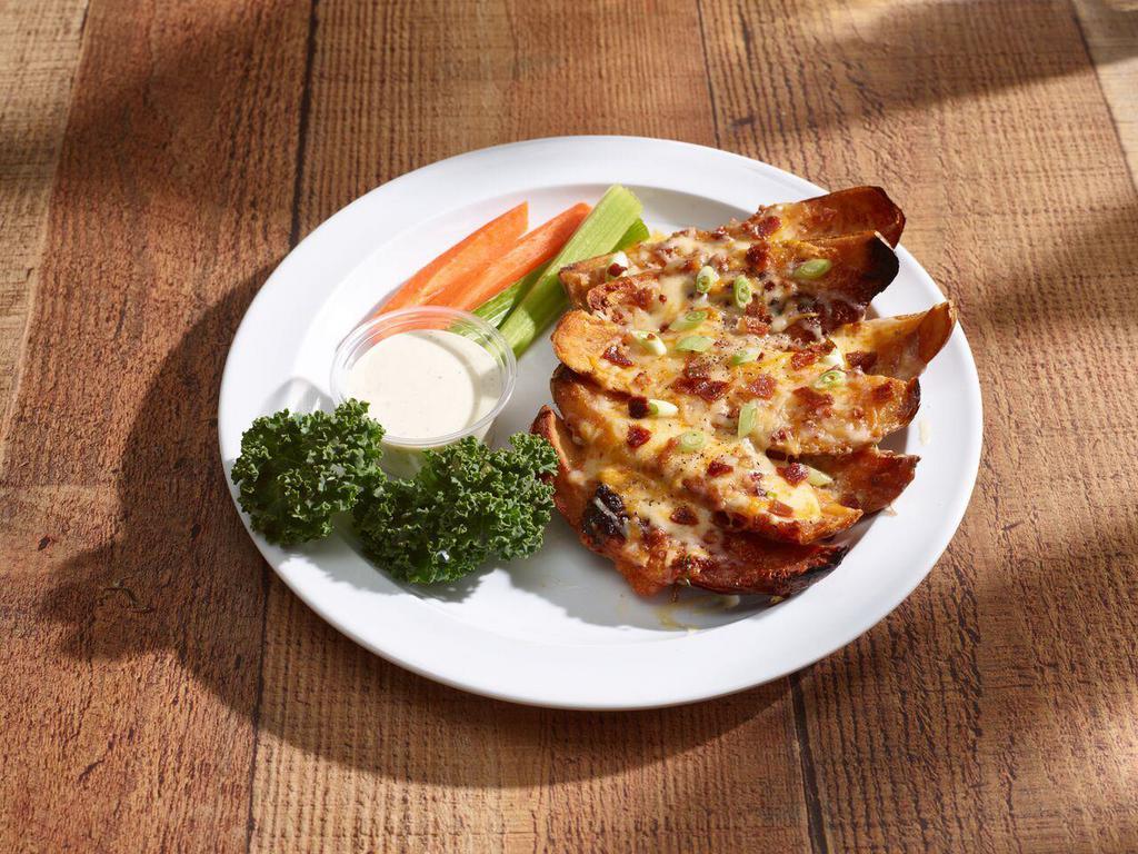 Potato Skins · Hickory-smoked bacon, cheddar cheese, Jack cheese, topped with green onions. Served with celery, carrot sticks and ranch dressing.