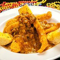 Cat-Touffee · Southern fried catfish glazed with crawfish etouffee over a bed of rice.