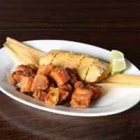 Tamal en Hoja con Chicharroncito de Puerco · Hand rolled traditional Cuban tamale steamed and wrapped in a corn husk. Served with pork sk...