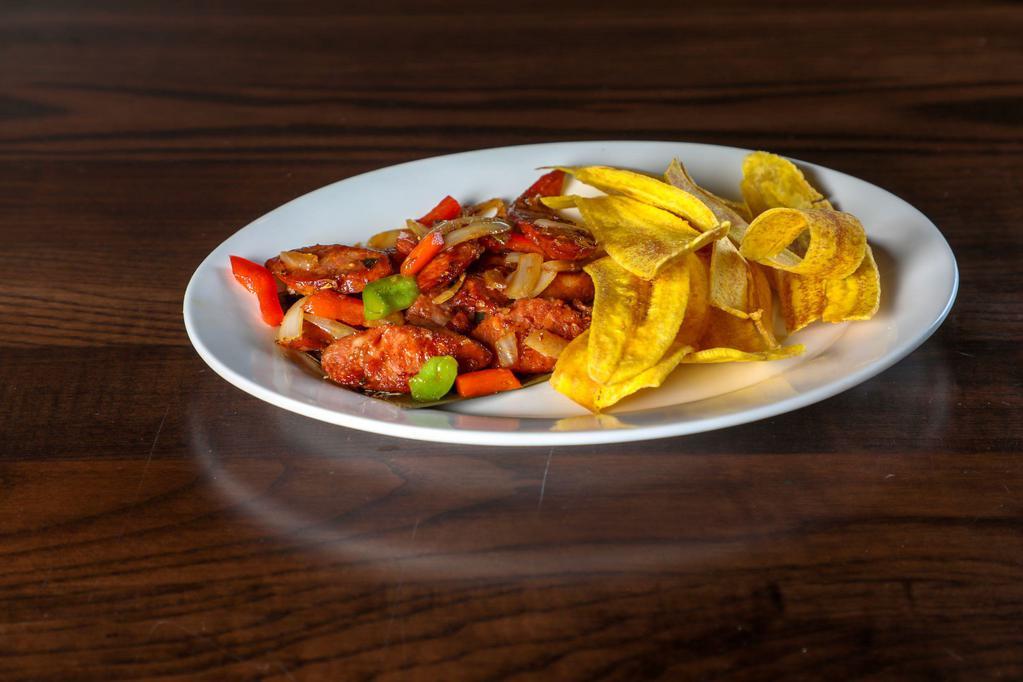 Chorizo Salteado · Sauteed Spanish sausage with onions, peppers, and a hint of garlic served with plantain chips.
