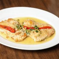 Pollo al Ajillo · Boneless chicken breast cooked in a garlic & wine sauce, green peas, & roasted bell peppers