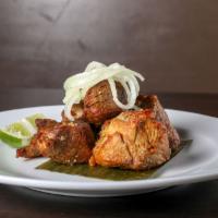 Masas de Puerco Frita · A Cuban tradition. Fried lean chunks of pork, marinated in our special garlic mojo and toppe...