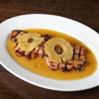 Chuleta Ahumada con Pina · Smoked pork chops slowly cooked and topped with caramelized pineapple slices.