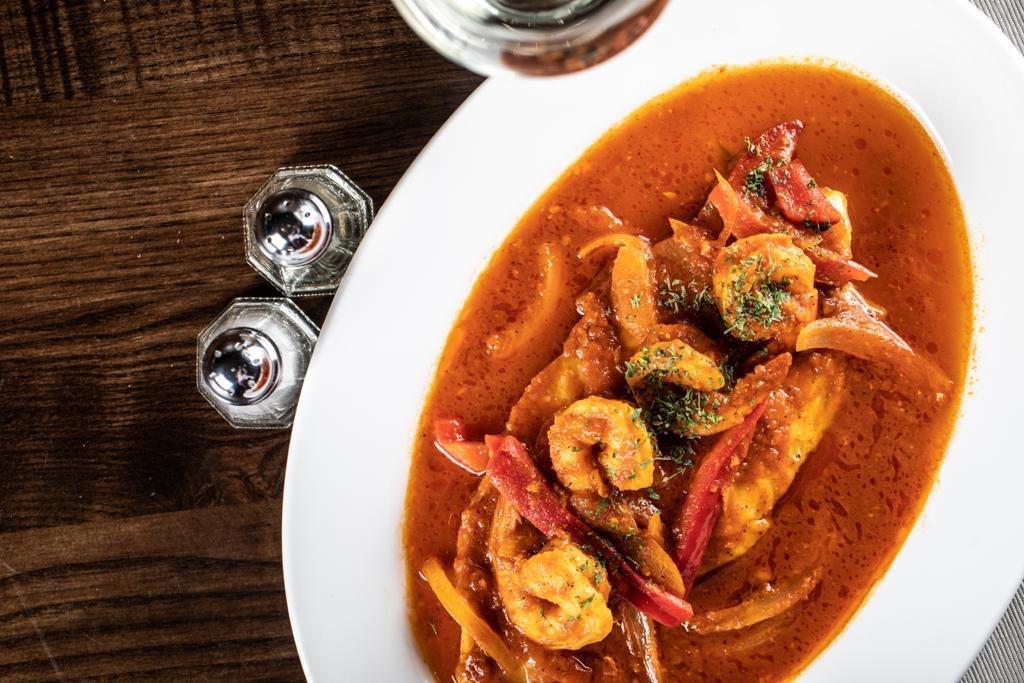Enchilado de Camarones · Shrimp sauteed in our homemade zesty Red  creole sauce, bell peppers & onions
