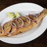 Pargo Frito Entero · Whole red snapper marinated, deep fried and topped with raw onions.