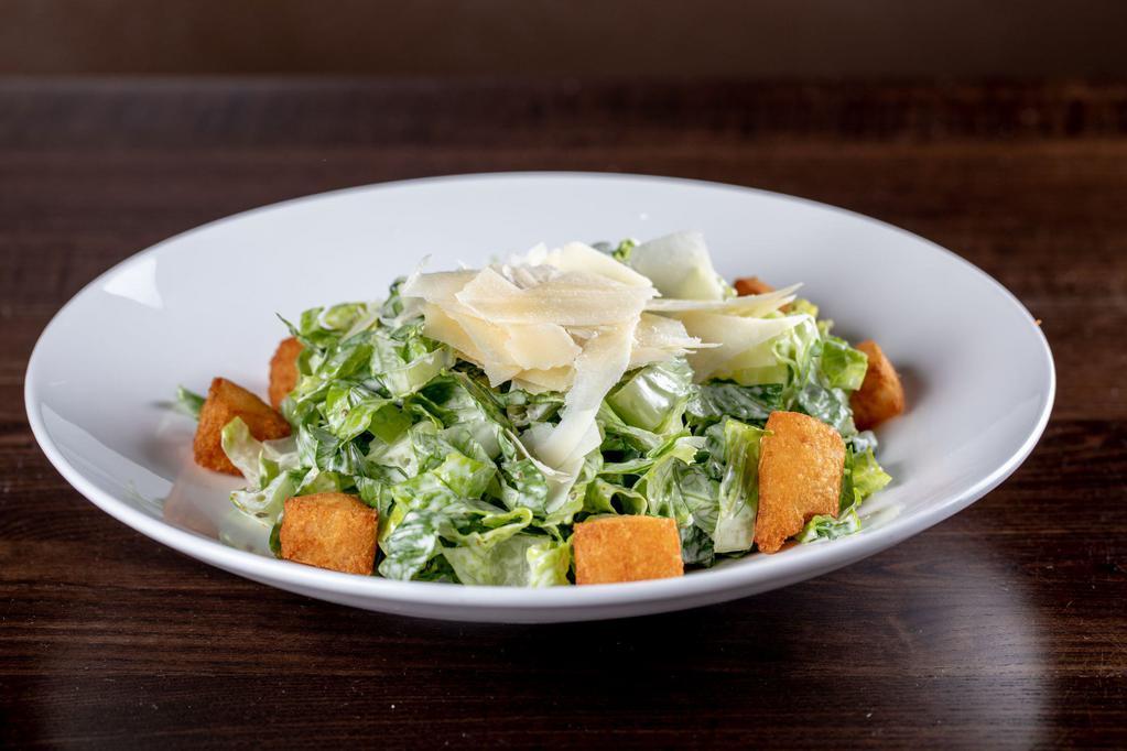 Ensalada de Caesar Caribena · Hearts of romaine tossed in a homemade cilantro Caesar dressing topped with yuca croutons and shaved cheese.