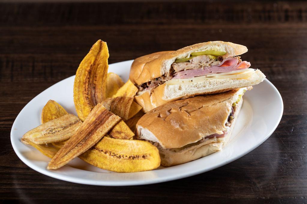 Sandwich Cubano · Our classic pressed sandwich made with our delicious slow-roasted pork, ham, pickles, Swiss cheese on Cuban Bread.