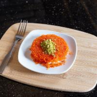 Kenafeh · Shredded katafie dough filled with soft white cheese, topped with rose water syrup and chopp...