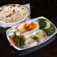 Mezza Plate Sampler · Order of hummus, baba ghanouj, tabouli salad, grape leaves and falafel topped with tahini sa...
