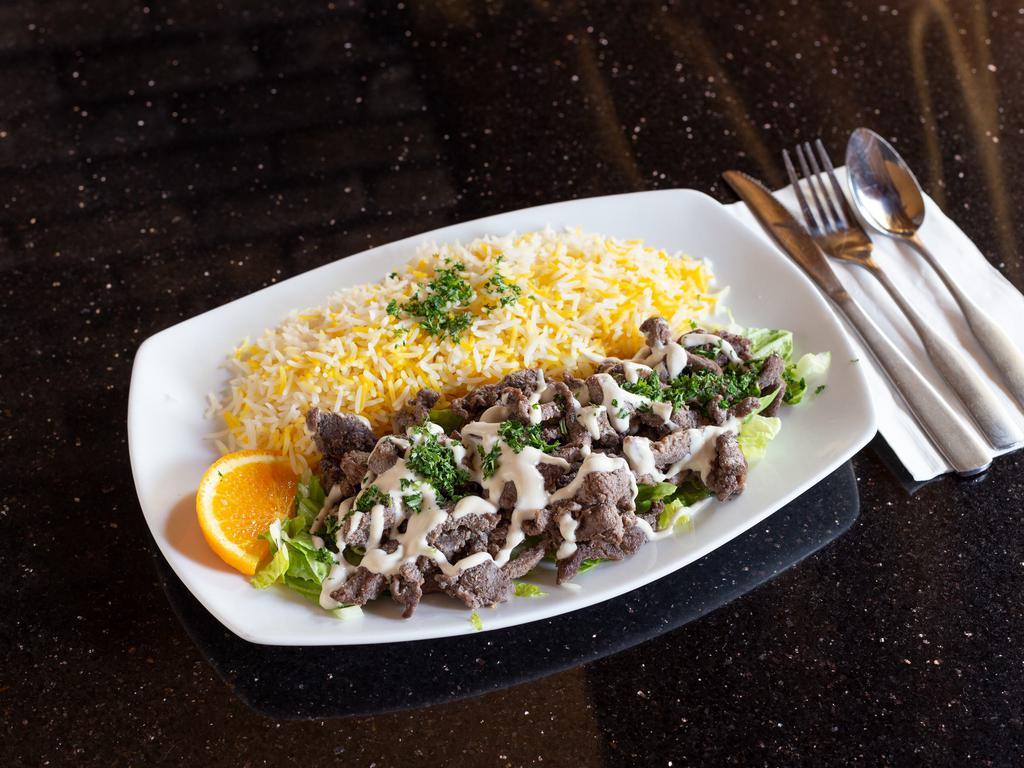 Lamb Shawerma Plate · Marinated lamb on a bed of lettuce, topped with tahini sauce. Served with basmati rice. Gluten free and halal.