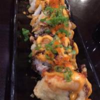 Better than Mike Tyson Roll · Deep fried roll. Asparagus, avocado, crab mix and cream cheese. Topped with salmon, tempura ...